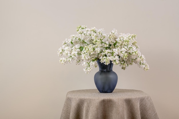 A vase of white flowers on a table