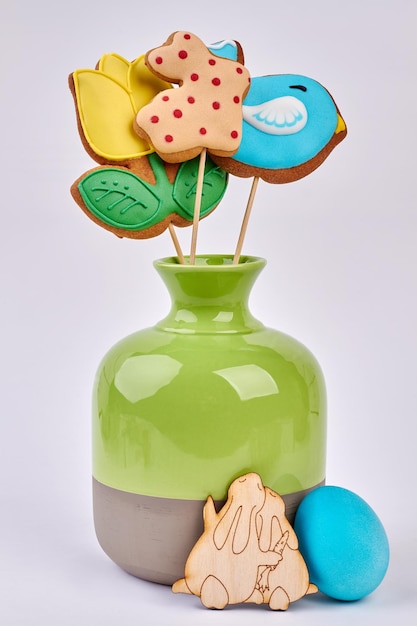 Vase with Easter cookies isolated Wooden rabbits cutout Share the taste of holiday