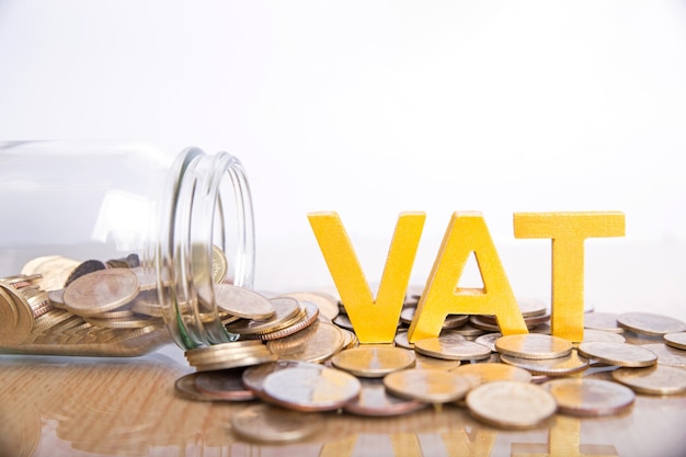 Vat Concept. Word vat put on coins and glass bottles with coins inside on white background.