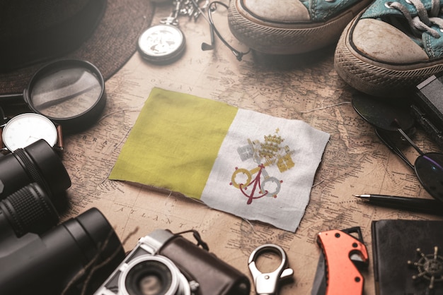 Vatican City Flag Between Traveler's Accessories on Old Vintage Map. Tourist Destination Concept.