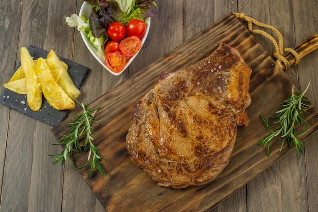 Veal chop with potatoes and vegetables