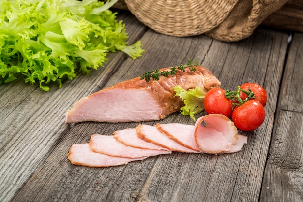 Veal roast with vegetables. Organic products on a wooden table