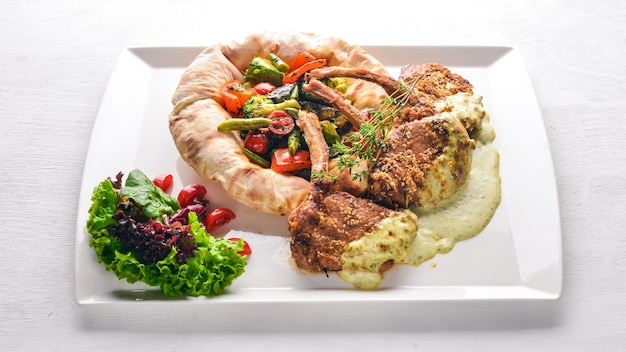 Veal steak on the bone Grilled vegetables Top view Free space for text On a wooden background