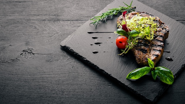 Veal steak cooked on grill On a wooden background Top review Free space