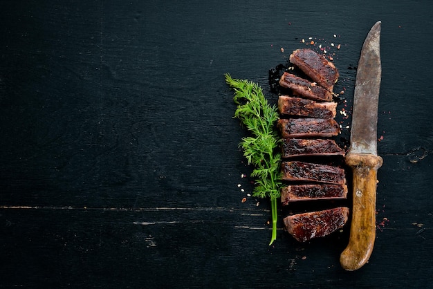 Veal steak On a wooden background Top view Free space for your text