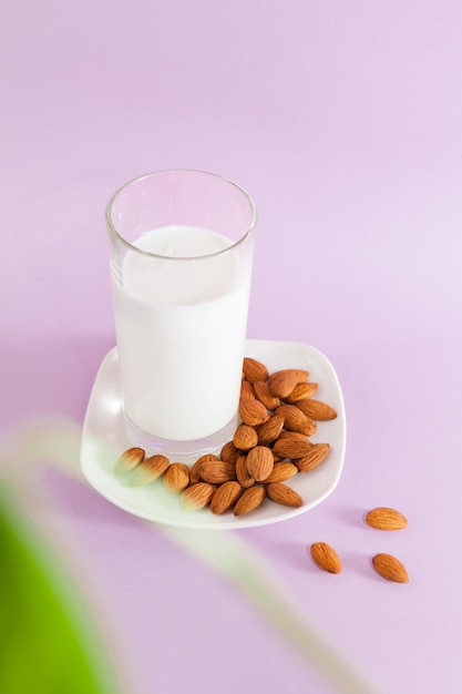 Vegan almond nut milk dietary healthy drink on a pink backgrounnd top perspective view