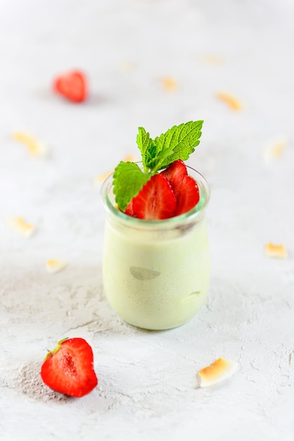 Vegan avocado dessert with fresh strawberries and mint