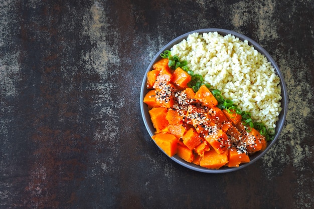 Vegan bowl with bulgur and pumpkin. Healthy vegan food in a bowl.