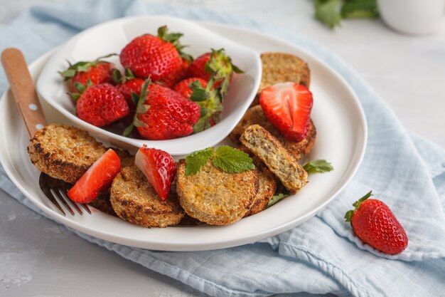 Vegan breakfast sweet tofu fritters with strawberries.