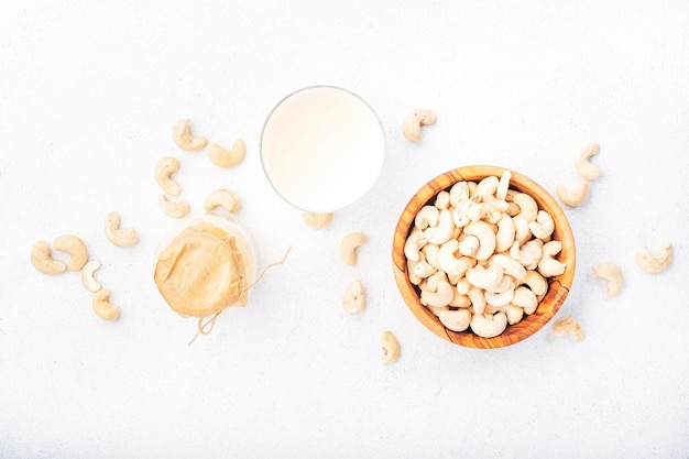 Vegan Cashew nut milk in bottles closeup white table background Non dairy alternative milk Healthy vegetarian food and drink concept Copy space