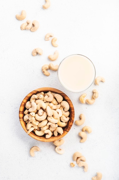 Vegan Cashew nut milk on white background Non dairy alternative vegan drink Healthy vegetarian food and beverage Copy space top view