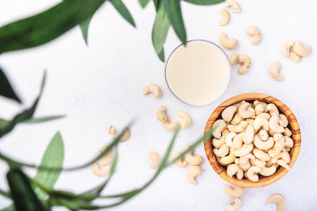 Vegan Cashew nut milk on white background Non dairy alternative vegan milk Healthy vegetarian food and drink Copy space top view