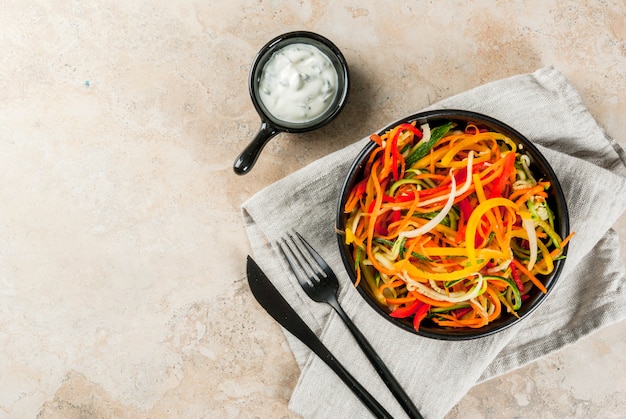 Photo vegan food, diet. vegetable noodles, pasta from carrot, zucchini, bell pepper