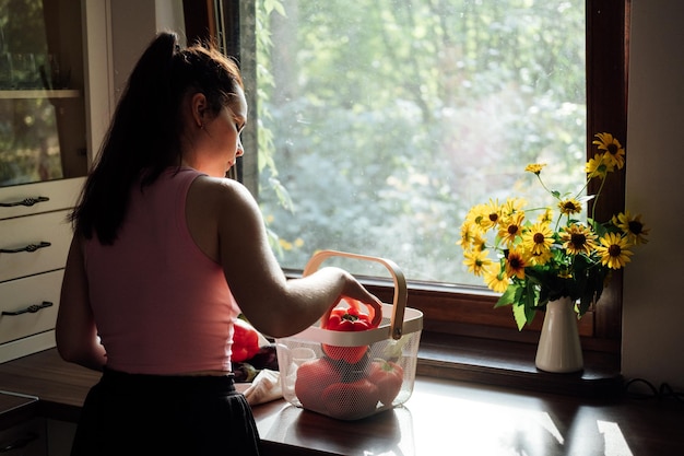 Vegan food and health vegans eat young latina woman holding red bell pepper near vegetables on table