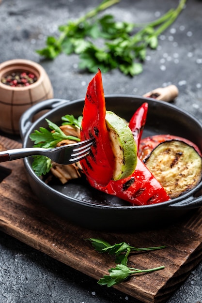 Vegan grill menu. Grilled vegetables in a cast iron grilling pan, Food recipe background. Close up.