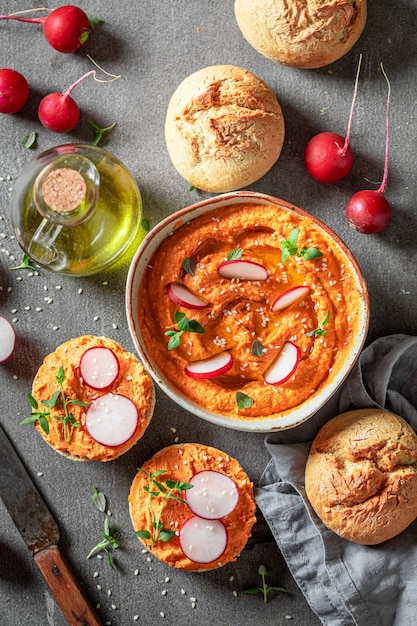 Vegan and homemade roll with tomato hummus radish and herbs