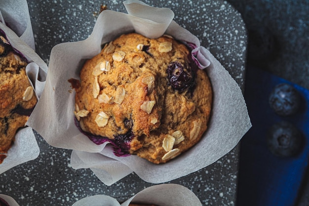 Vegan oatmeal banana blueberry muffins on blue background Plant based dessert