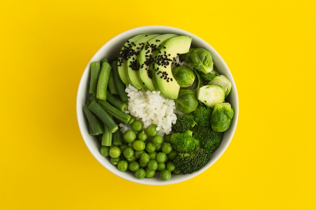 Vegan poke bowl with rice and green vegetables in bowl