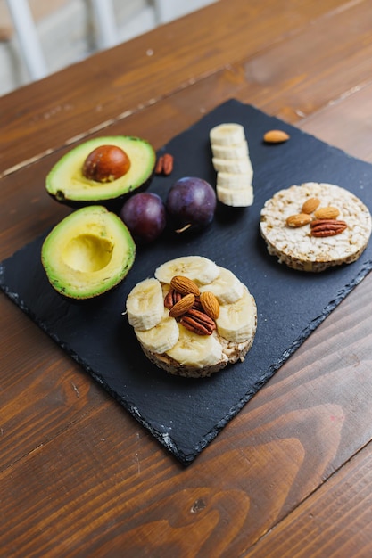 Vegan rice bread for breakfast with avocado and plums Healthy Eating