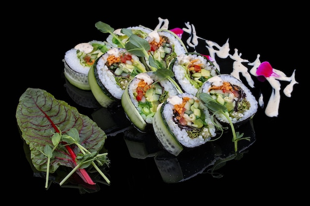 Vegan roll with daikon avocado chukka and peppers on glossy black background