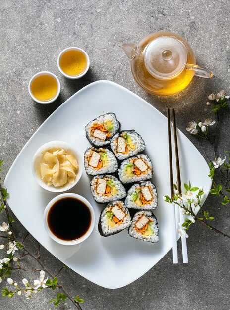 Vegan sushi with tofu in General Tso sauce, avocado and fresh vegetables