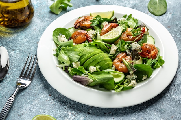 Vegan vegetarian dinner background. Green salad with avocado, blue cheese and smoked shrimps. Healthy eating concept. Detox diet. Vegetarian lunch. Weight loss. Cleanse program.