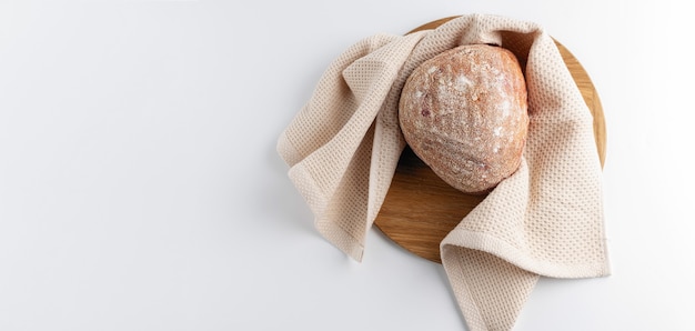 Vegetable bread on a wooden board top view, light background, banner, empty space for text