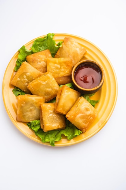 Vegetable Chinese samosa is a square shape a deep-fried snack prepared with homemade pastry sheets and tasty noodles stuffing