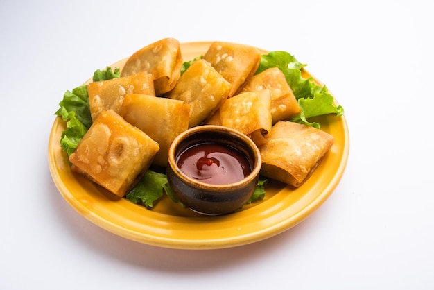 Vegetable Chinese samosa is a square shape a deep-fried snack prepared with homemade pastry sheets and tasty noodles stuffing