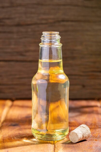 Vegetable oil in glass container on wooden surface