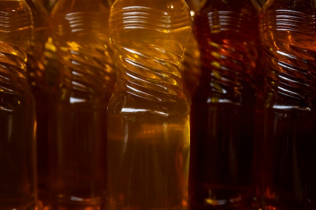 Vegetable oil in plastic bottles. Natural homemade product. Close-up. Background. Health and vitamins from nature.