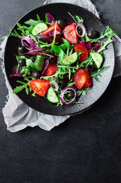 Vegetable salad tomato, arugula, lettuce, olives vegetables keto