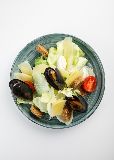 Vegetable salad with cheese and mussels