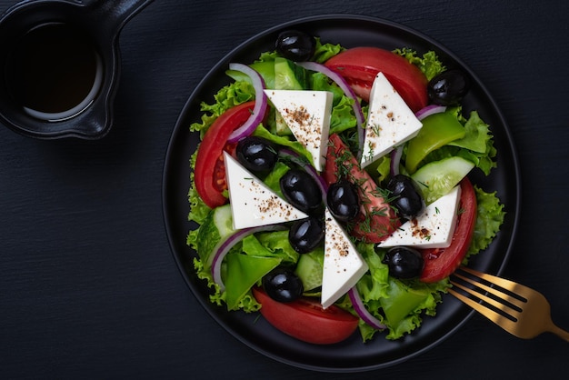 Vegetable salad with fresh cucumber tomato olive onion lettuce and feta cheese Healthy food