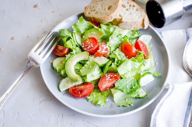 Vegetable salad with fresh tomato, cucumber, avocado