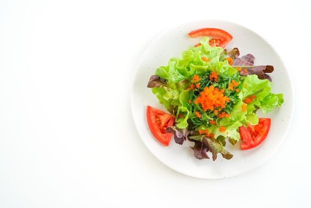 vegetable salad with Japanese seaweed and shrimp eggs on white table