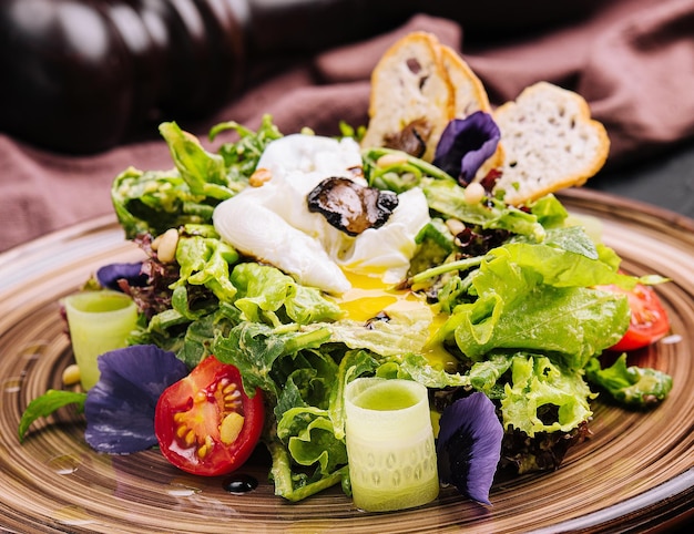 Vegetable salad with poached egg on a plate