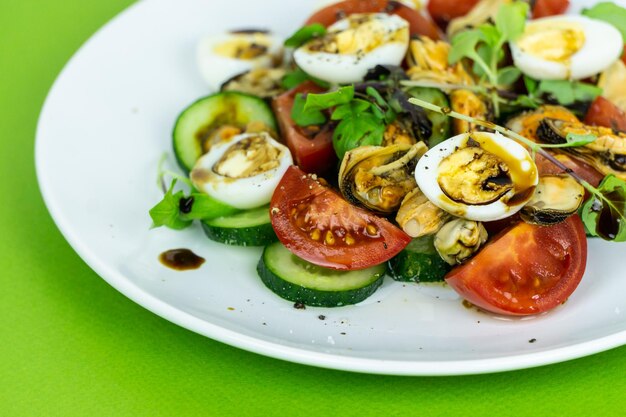 A vegetable salad with quail eggs and mussels