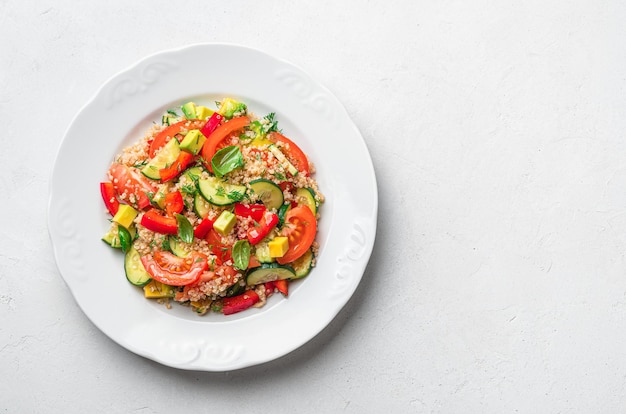 Vegetable salad with quinoa dill basil on a gray background Tabbouleh salad Top view copy space