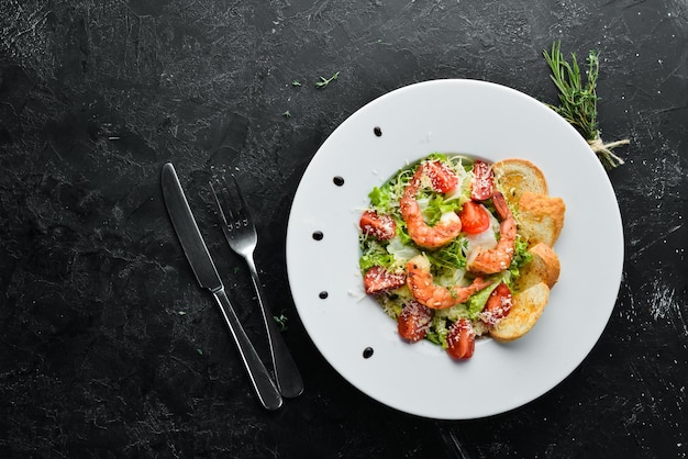 Vegetable salad with shrimp and cherry tomatoes Caesar salad with prawns Top view Free space for your text