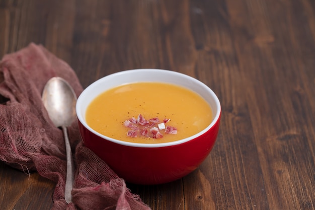 Vegetable soup with smoked meat in bowl