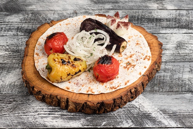 Vegetables baked vegetables on a wooden white background