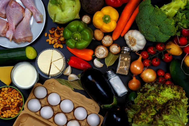 vegetables and diet food on a black background, top view, flatley