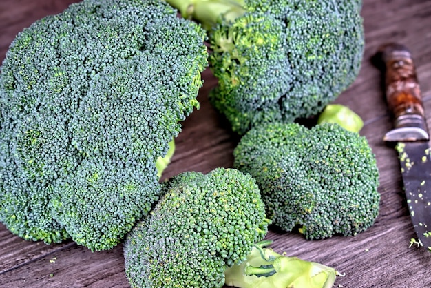 Vegetables, diet, healthy eating and objects concept-green broccoli on a wooden table.