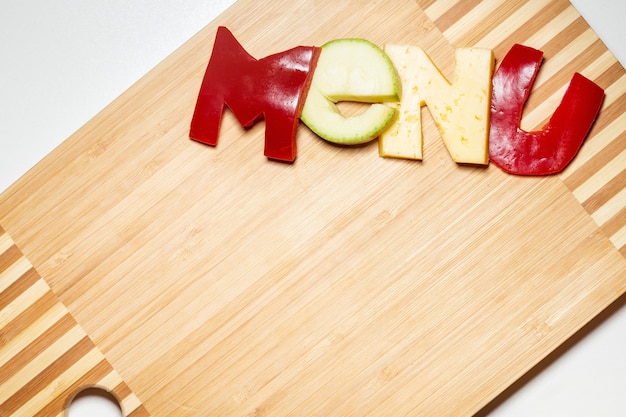 Vegetables in the form of letters on a cutting board