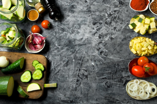 Vegetables . Fresh vegetables (cucumbers, tomatoes, onions, garlic, dill, green beans) on a gray background. Top view. copyspace