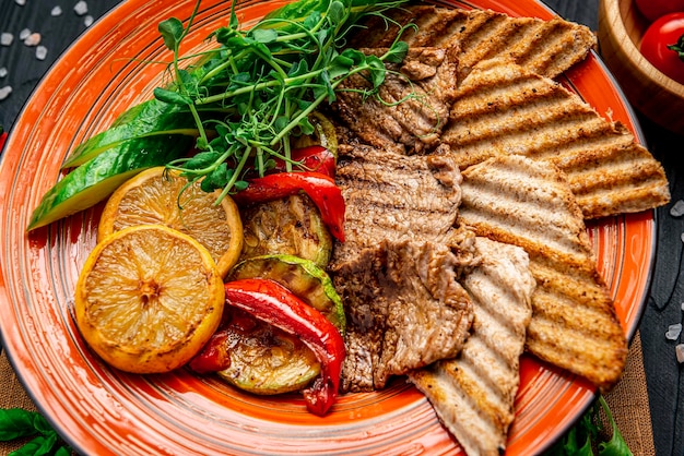 Vegetables and meat cooked on an electric grill