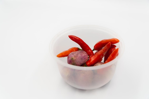 Vegetables onion and cayenne pepper in bowl on white background