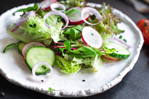 Vegetables salad radish cucumber mix leaves petals meal snack keto or paleo diet