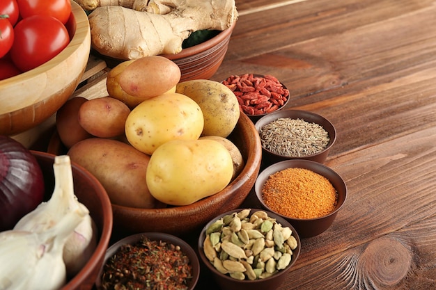 Vegetables and spices on wooden table